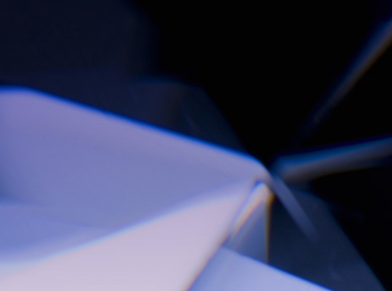 An abstract close-up image of a large diamond